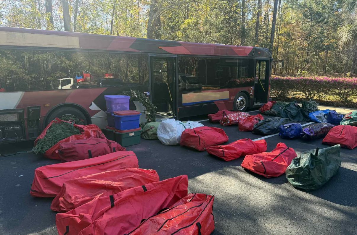 Bags of donated artificial Christmas trees lined up beside the Christmas bus