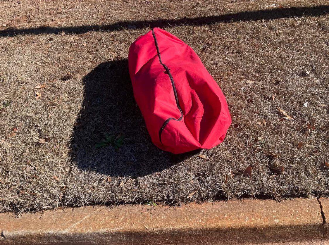 A red tree bag left at the curb