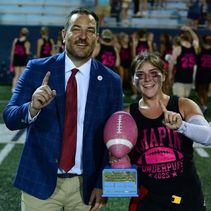 Gabriel Penfield with a player holding the powderpuff football trophy