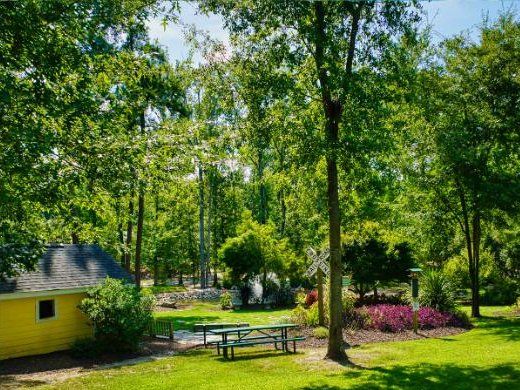 Playhouse and picnic tables by the garden