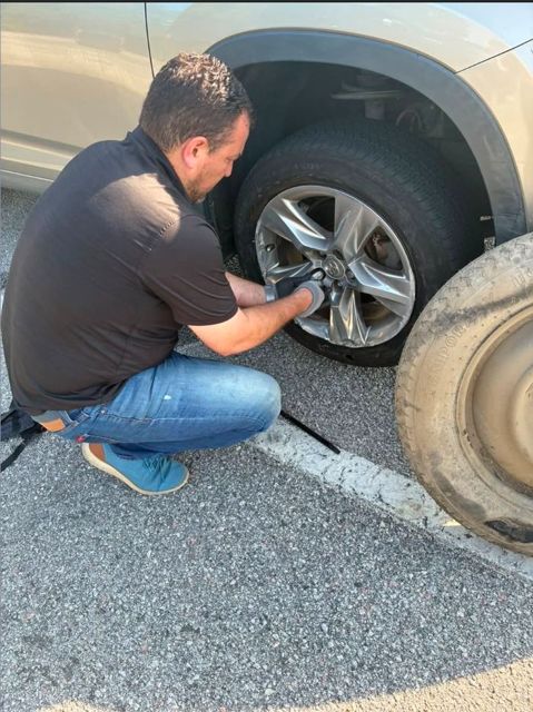 Gabriel changing a neighbor's flat tire