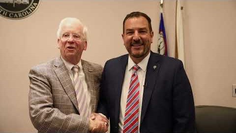 Gabriel Penfield shaking hands with Mayor Bill Danielson